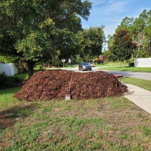 big pile of mulch with shovel